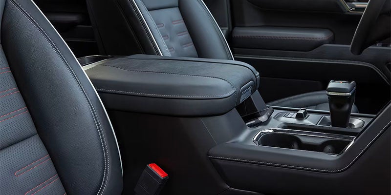 Close-up of GMC Sierra Denali’s black leather front seats and center console