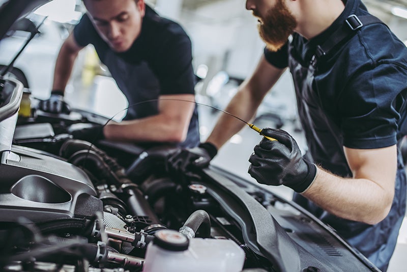 A technician installing a car battery.