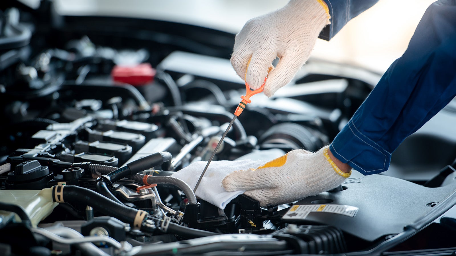 A technician servicing vehicle.